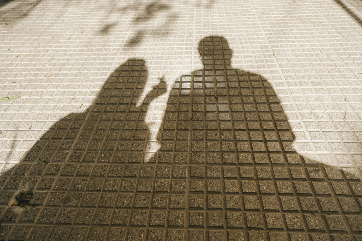 Two people in focused conversation, represented through their shadows