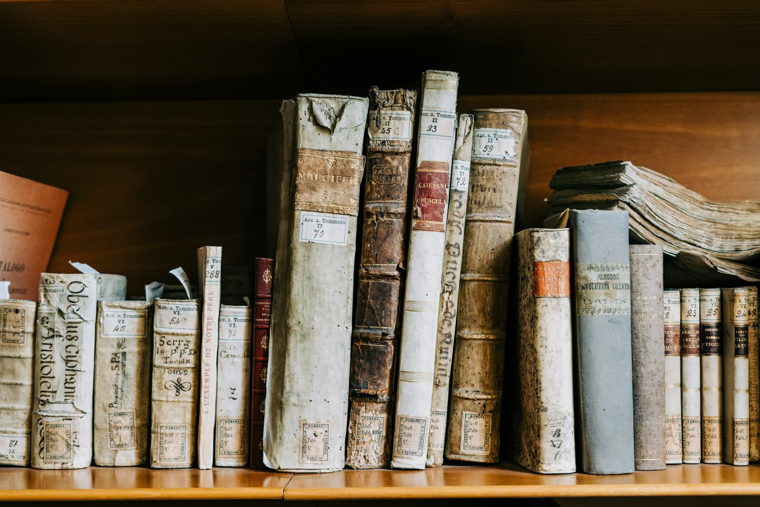 A shelf of timeworn books representing the records organizations carry