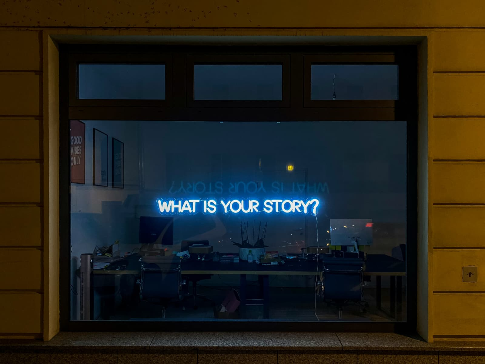 A nighttime window installation asking What is your story?
